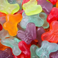 many colorful gummy bears are stacked on top of each other in the shape of butterflies