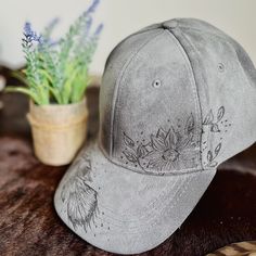 A one-of-a-kind hat, with a unique design hand-burned by our talented artist. Embracing the art of pyrography, this baseball cap is a must-have accessory for any cowboy or cowgirl. Includes an adjustable back strap. We are happy to take custom orders. Please reach out with the design you are looking for!                                                                                          Bundle and save! Do you have a friend or family member who also wants an awesome unique hat? Do you have Hat Burning Designs, Hat Burning, Custom Baseball Hats, Hand Burn, Tiny Clothes, Painted Hats, Unique Hats, Western Design, Cow Girl