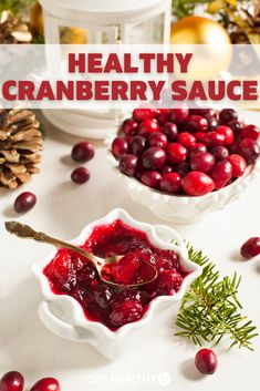 cranberry sauce in small white bowls on a table with pine cones and greenery