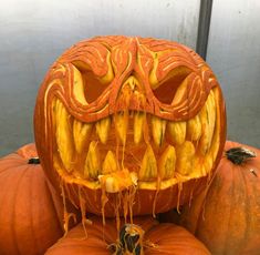 carved pumpkins with faces and teeth on them