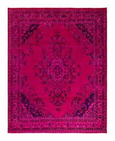 a pink rug with an ornate design on the center and purple border, in front of a white background