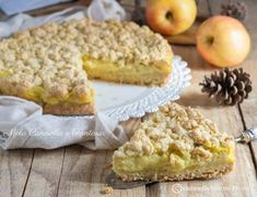 an apple crumb pie on a plate with one slice cut out and another piece missing