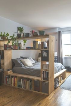 a bedroom with a bed, desk and bookshelf filled with lots of books