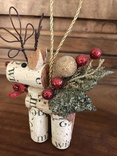 a christmas decoration made out of wine corks and other items on a wooden table