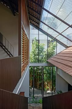 the inside of a building with glass walls and metal railings on either side of it