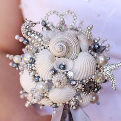 a bridal bouquet with seashells and pearls