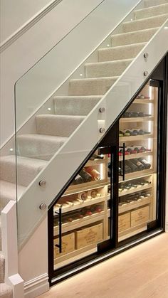 an open refrigerator under the stairs in a home