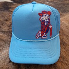 Espy Threads Original Ole Miss Snapback Trucker Hat With Embroidered Colonel Reb Patch. Retro Blue Trucker Hat For Beach, Blue Snapback Hat With Short Brim For Summer, Retro Blue Snapback Hat With Curved Brim, Blue Summer Snapback Hat With Short Brim, Retro Blue Cap Hat, Retro Blue Cap, Blue Retro Cap, Retro Blue Trucker Hat, Blue Retro Trucker Hat With Flat Brim