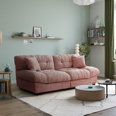 a living room with a pink couch and coffee table