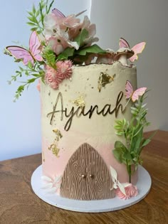 there is a cake with flowers on it and the words asynah written in cursive writing