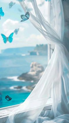 there are many blue butterflies flying out of the window and in front of the ocean