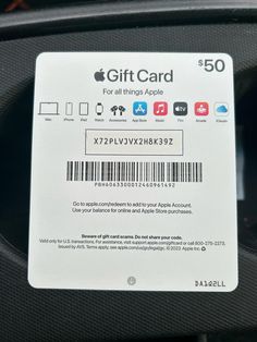 an apple gift card sitting on the back of a car seat in front of a speaker