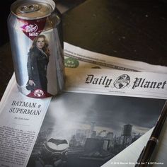 a can of beer sitting on top of a newspaper