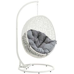 a white swing chair with grey cushions on it's stand and the seat is up