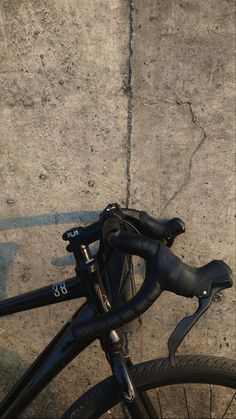 a close up of a bike parked on the sidewalk