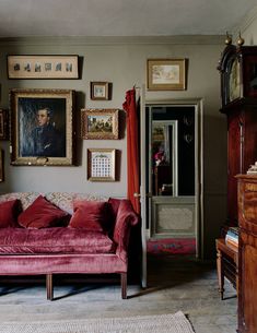 a living room filled with furniture and pictures on the wall