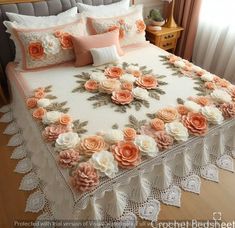 a bed covered in pink and white flowers next to a window