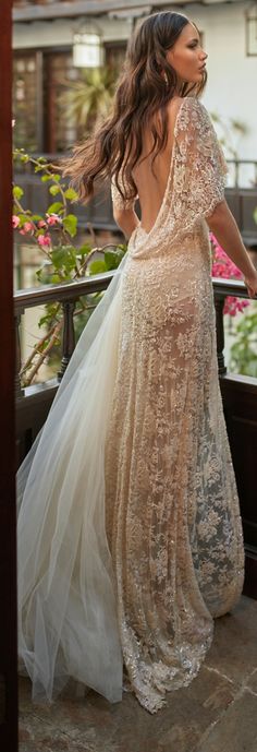 a woman in a dress standing on a balcony