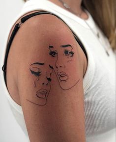 a woman's arm with a drawing of two women on it