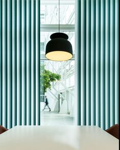 a dining room table with chairs and a light hanging from the ceiling