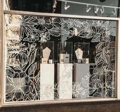 a store front window with white flowers on it