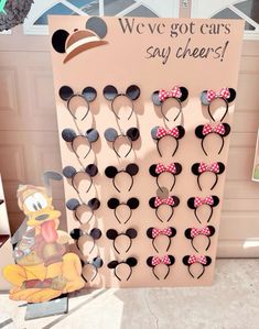 mickey mouse ears are on display in front of a sign