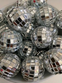 a bowl full of disco balls sitting on top of a table