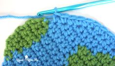 a crocheted blue and green piece of yarn