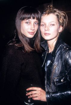 two beautiful young women standing next to each other