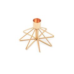 a gold candle holder on a white background