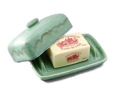 two soap bars sitting on top of a green tray next to each other in front of a white background