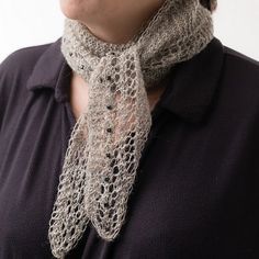 a woman wearing a knitted neck scarf with lace on the top and bottom part