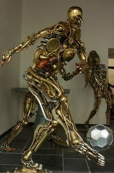 a large metal statue is standing in the middle of a room