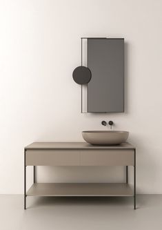 a bathroom with a sink and mirror on the wall