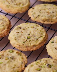 several cookies cooling on a wire rack in the oven, with pistachios