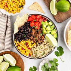 mexican salad in a bowl with tortilla chips and avocado on the side