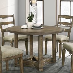 a dining room table with four chairs around it