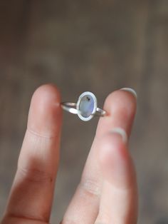 This dainty and extremely delicate ring features a beautiful Australian Lightning Ridge opal, set in a fine silver bezel with open back. The band is made with a sterling silver square wire. Size 6Handmade It's a perfect everyday ring - simple, yet full of character. Can be stacked and combined with other rings or worn by itself, for a more minimalist look. Delicate purples make each opal absolutely unique, with its own stunning colours and inclusions. The look of the gemstone changes in differen Delicate Oval Sterling Silver Rings, Sterling Silver Oval Midi Rings For Gift, Oval Sterling Silver Midi Rings For Gift, Minimalist Opal Ring With Bezel Setting As Gift, Handmade Minimalist Adjustable Birthstone Ring, Handmade Adjustable Minimalist Birthstone Ring, Minimalist Oval Sterling Silver Stackable Rings, Delicate Adjustable Opal Ring For Promise, Handmade Sterling Silver Opal Promise Ring