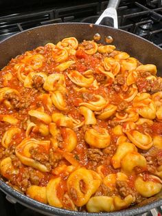 a skillet filled with pasta and meat sauce