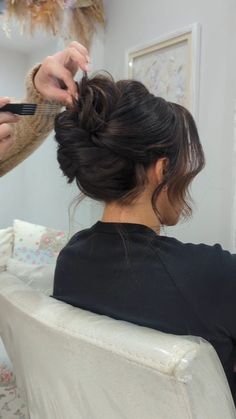 a woman is getting her hair done in a salon