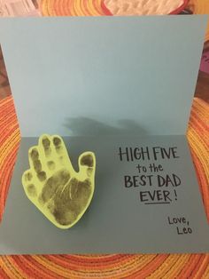 a brooch that is sitting on top of a card with the words high five to the best dad ever