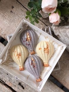 three decorative hot air balloons in a box