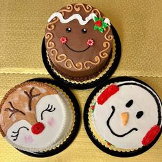 three decorated cakes sitting on top of a table