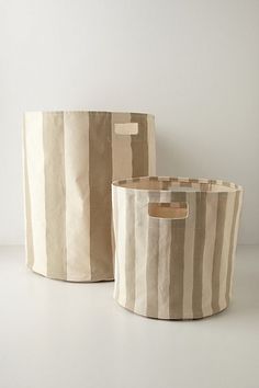 two striped storage baskets sitting next to each other