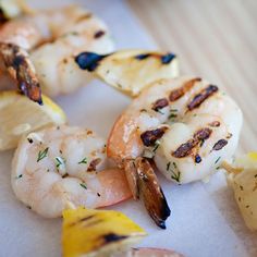 shrimp and pineapple skewers with lemon wedges