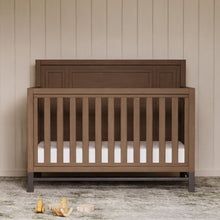 a baby crib in the corner of a room with two stuffed animals on the floor