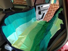 there is a colorful blanket in the back seat of a car