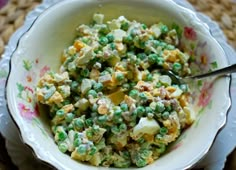 a white bowl filled with peas and eggs