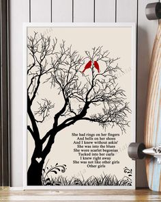 a red bird sitting on top of a tree next to a white board with the words she