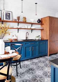 a kitchen with blue cabinets and white walls